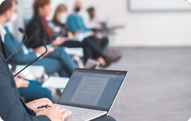 A picture of a CART interpreter typing on a small laptop during a meeting.