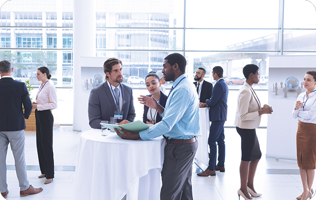 A picture of conference attendees talking to each other.