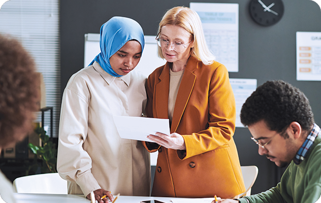 Picture of an instructor talking to a student during a language proficiency assessment.