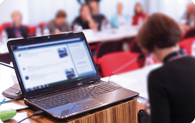 A picture of a laptop with a blurred screen being used for CPrint services during a meeting.