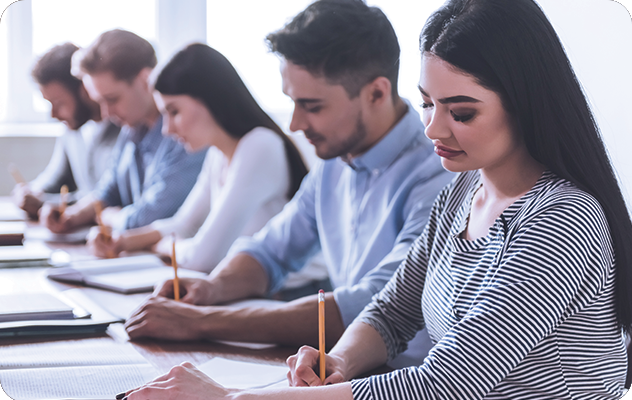 A group of students taking notes during an interpreter training course.