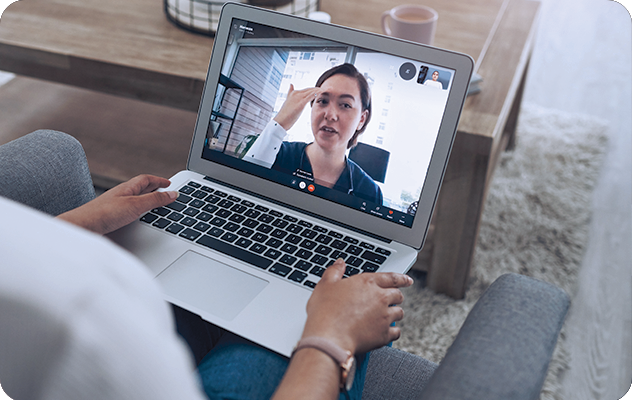 A picture of a patient talking to a telehealth professional on a laptop while using telemedicine interpreting.