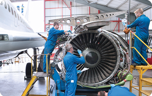 A picture of aerospace workers assembling a turbine.