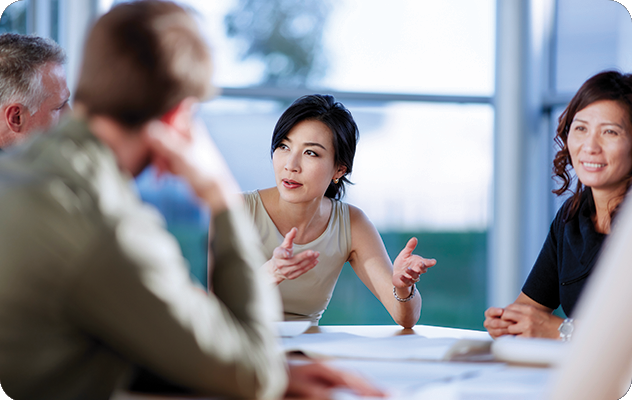 A picture of a female interpreter speaking for a client during an advertising meeting