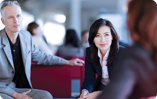 A picture of a businessman and female interpreter talking to a corporate partner.