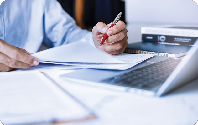 A picture of a set of hands reviewing documents for corporate translation services.