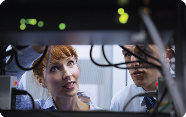 A picture of two IT professionals working on a server tower