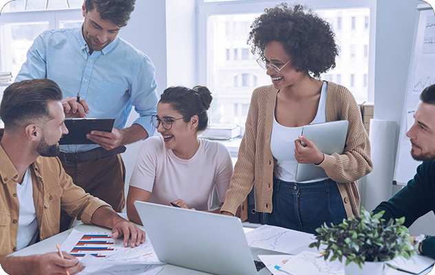 A picture of happy employees talking around a conference table