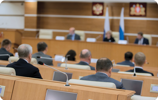 A picture of a group of government officials meeting in government chambers