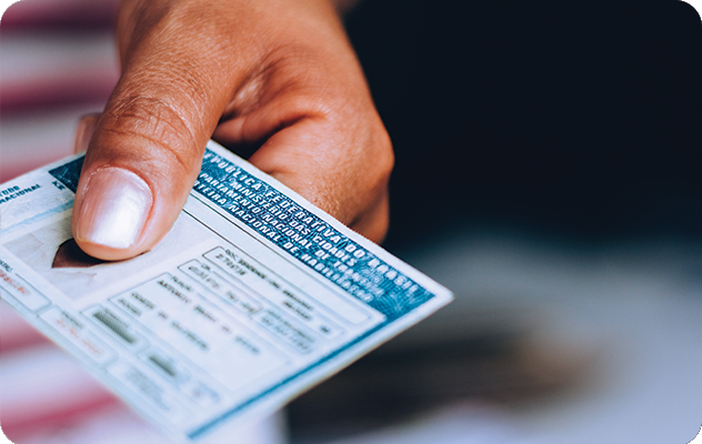 A picture of a hand holding a foreign identification card. iTi offers certified document translation for personal documents including identification cards.