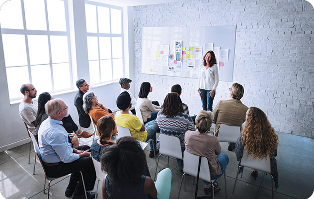 A picture of a diverse group of students sitting in a classroom for interpreter training.