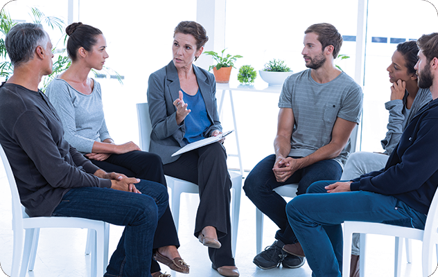 A picture of a group discussion in an addiction treatment facility with an interpreter present.