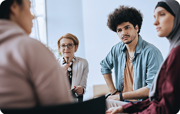 A picture of a young man listening to an interpreter in a mental health facility.