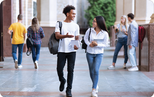 A picture of two students walking on a college campus