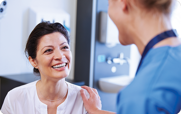 A picture of a nurse talking to a patient in a healthcare setting.