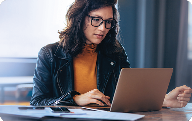 A picture of a female translator working on medical document translation on her laptop.