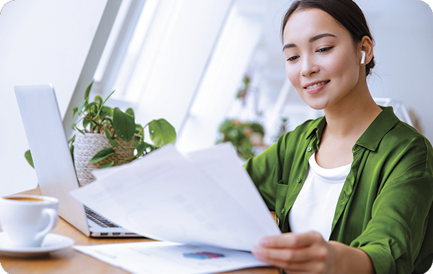 A picture of a young woman double checking documents during the transcription process.