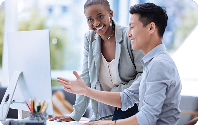 A picture of a female translator and male web designer looking at a computer for website localization services.