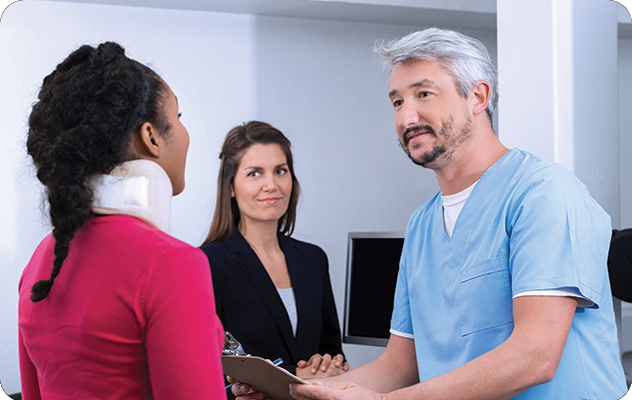 A picture of a nurse, an interpreter and a patient in a neck brace talking in a hospital room