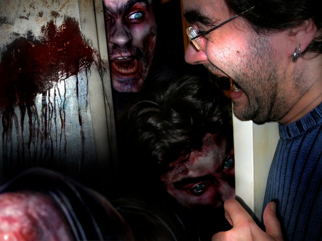 Scared man with zombies trying to break through a door