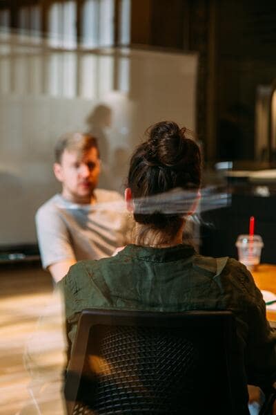 Two people sitting in a conference room