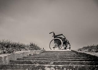 wheel chair sitting at the top of a staircase