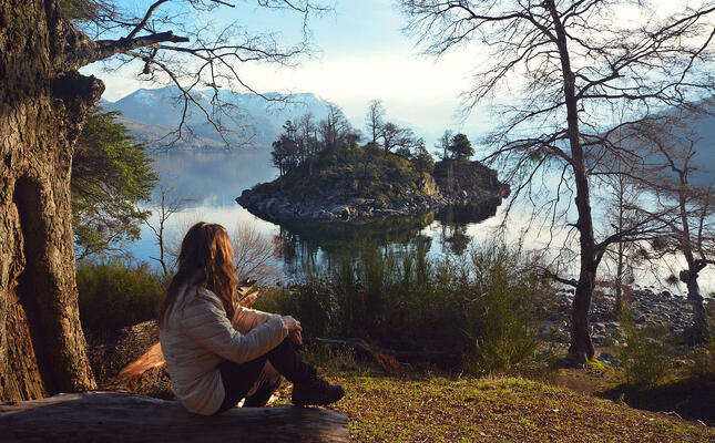 Terpii Travels to Argentina. Girl sitting on an overlook of a lake