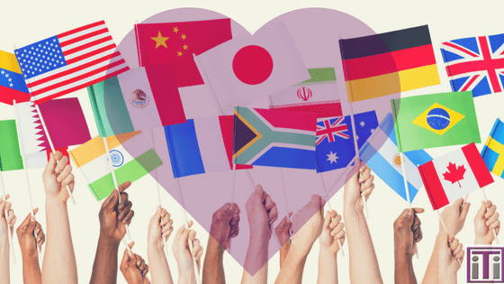 Various country flags being help up with a heart overlay