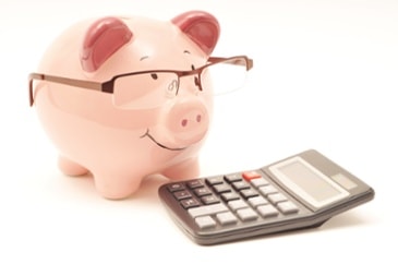 Piggy bank next to a calculator