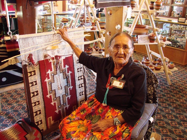 Elderly Navajo women making a rug