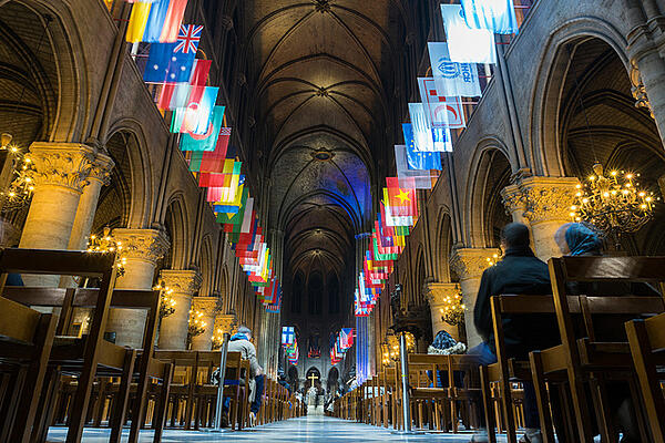 Inside of a beautiful church with a lot of countries flags