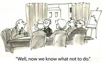 Cartoon of business people sitting around a table with the caption, "Well, now we know what not to do."
