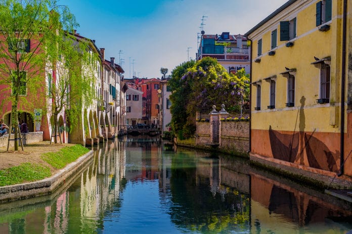 Beautiful and colorful canal through buildings in Italy