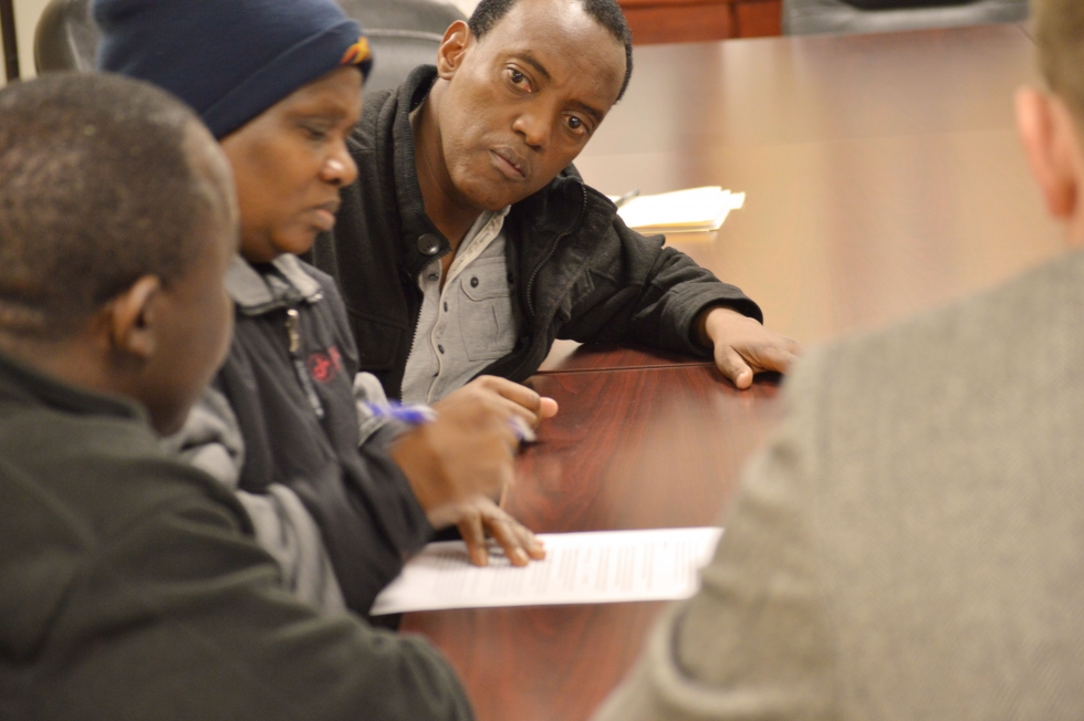 An interpreter helps a family at a counseling session.