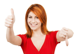 Woman with one thumb pointing up and the other pointing down.