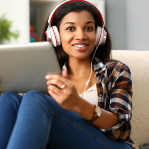 Black woman with tablet and headphones