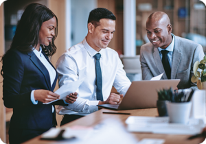 A picture of lawyers looking at a laptop around a conference table.