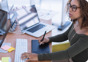 A picture of a woman working on a computer for multilingual desktop publishing services.