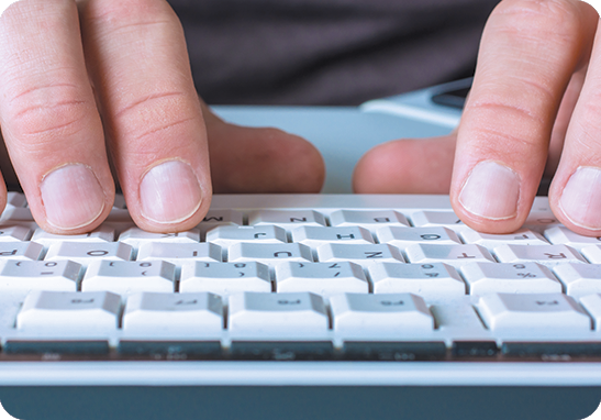 A picture of hands typing on a keyboard during transcription services
