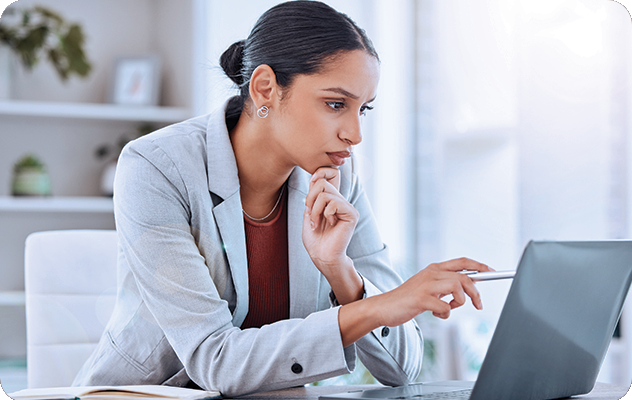 A picture of a business woman reviewing a localized website on her laptop computer.